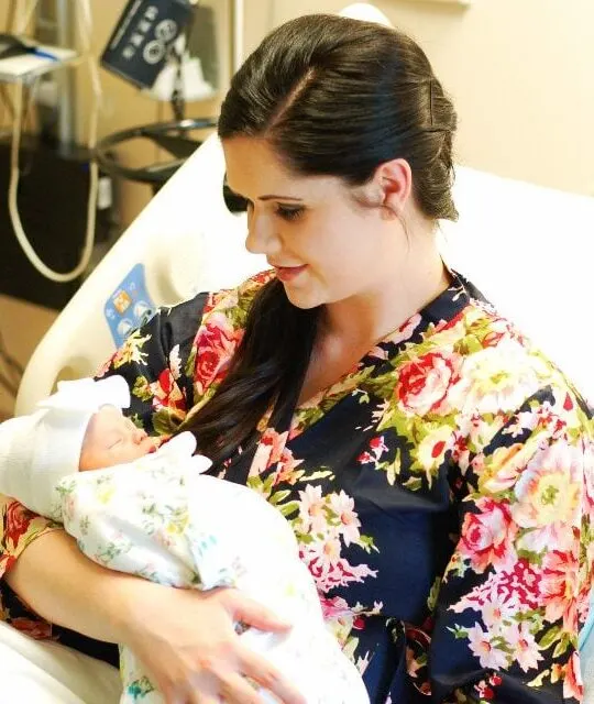 Mom holds new baby after giving birth