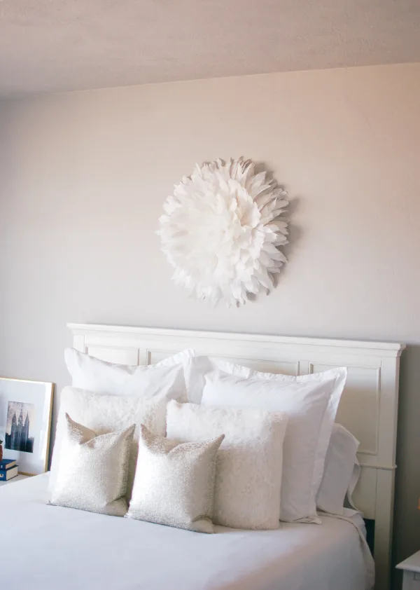 White Juju hat on a bedroom wall.