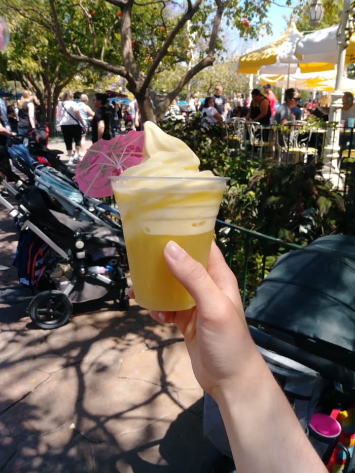 Woman holds Disneyland Dole Whip Dessert.