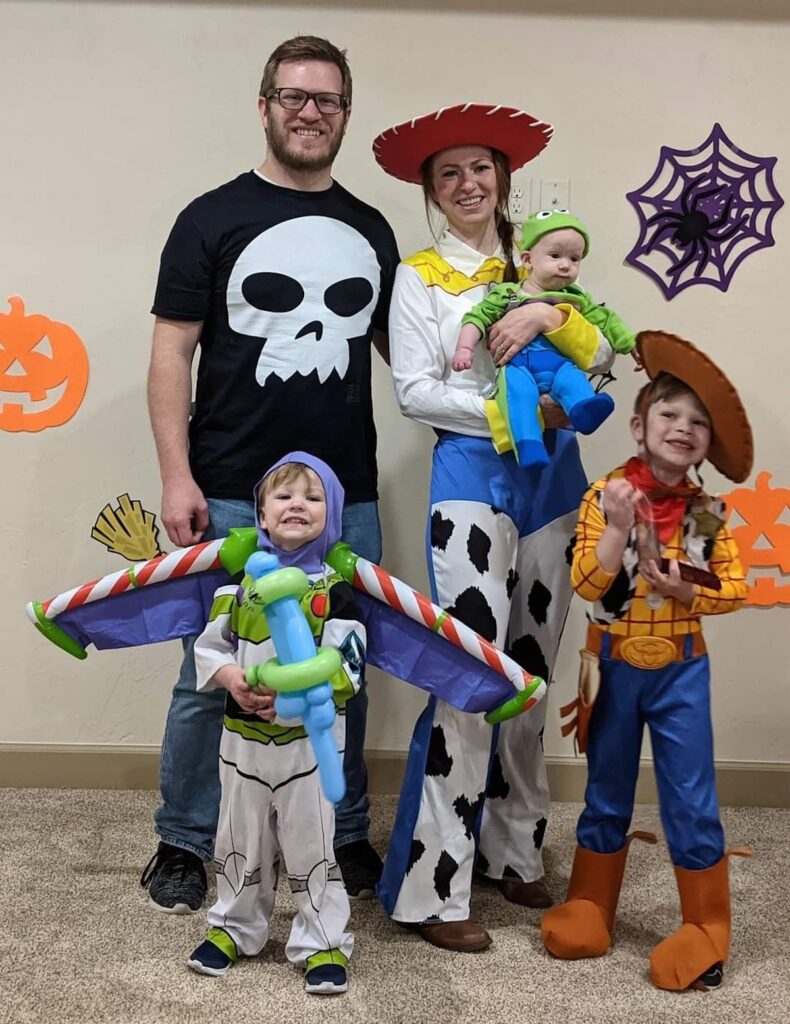 Family of 5 wears Toy Story themed costumes.