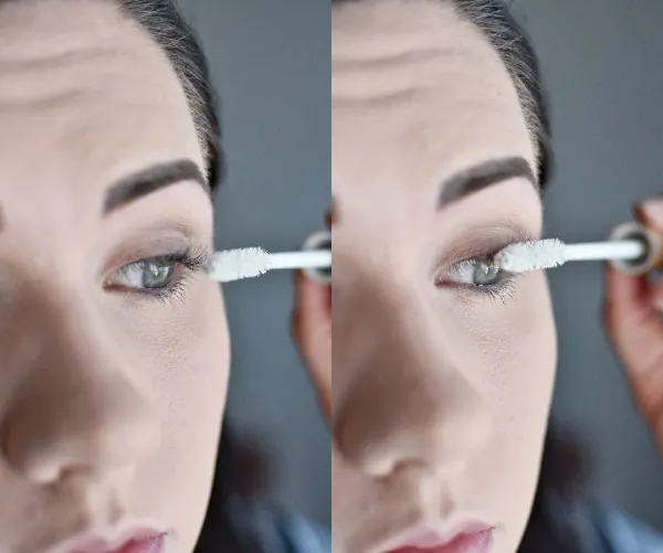 Woman applying mascara primer for an easy smokey eye tutorial 