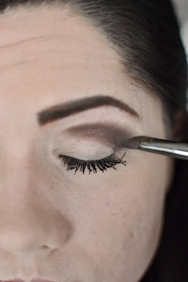 Woman blending eye shadow during an easy smokey eye tutorial 