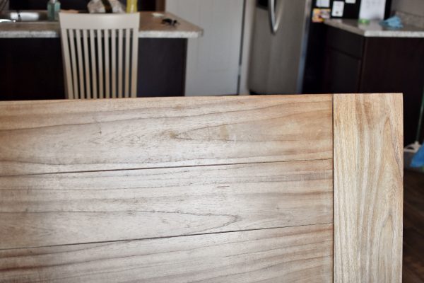 A scratched dining table that needs to be refinished