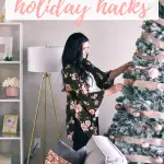 Pinterest graphic with text that reads "Seven of the Best Time-Saving Holiday Hacks" and a woman arranging decorations on a Christmas tree.