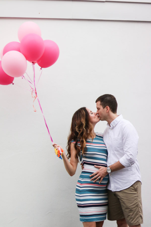 Couple announces baby's gender with pink balloons