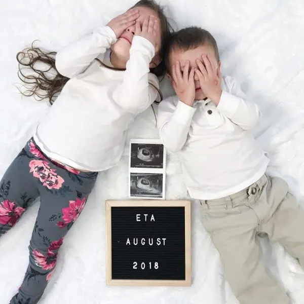 Two siblings with an ultrasound baby announcement
