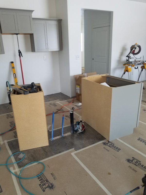 Cabinets being installed in a new house