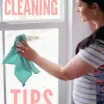 Pinterest graphic with text that reads "The Ultimate List of Spring Cleaning Tips" and a woman cleaning a window.