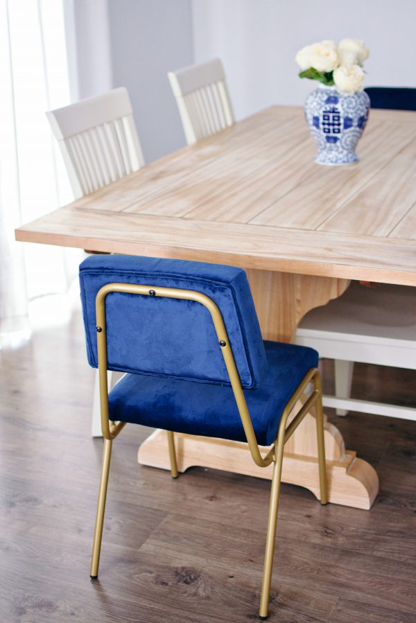 Refinished farmhouse table with bright blue modern chairs