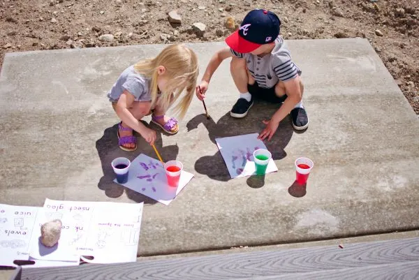 Boy and girl doing crafts outside.