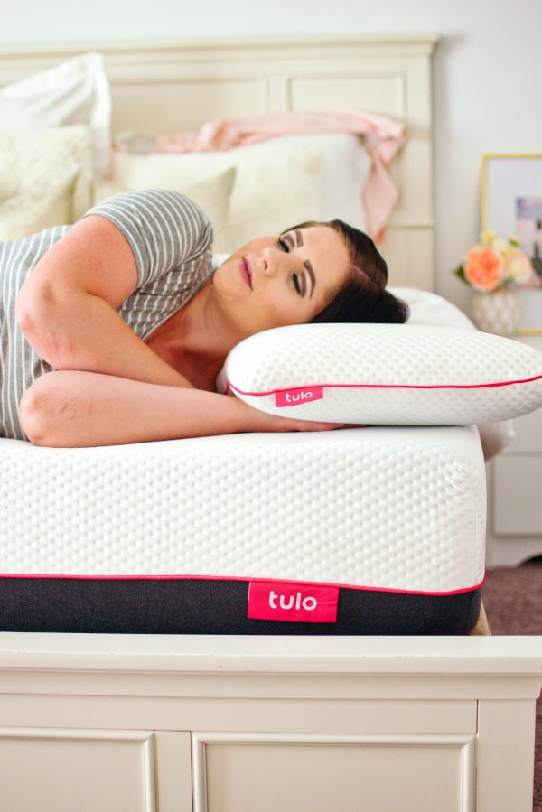 A pregnant woman sleeps comfortably on her tulo mattress.