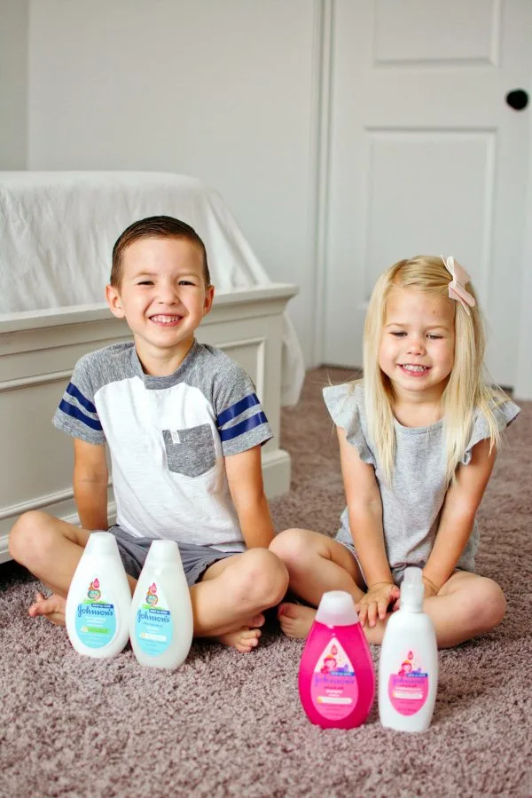 Two children sit with their kids hair products.