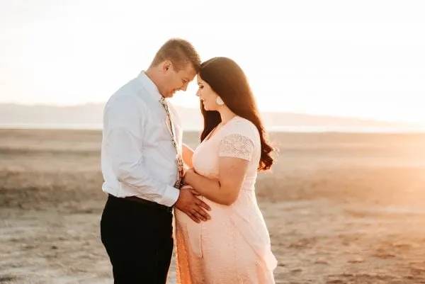 Woman takes maternity pictures with husband.