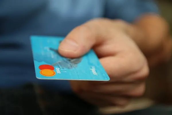 Man holds credit card.