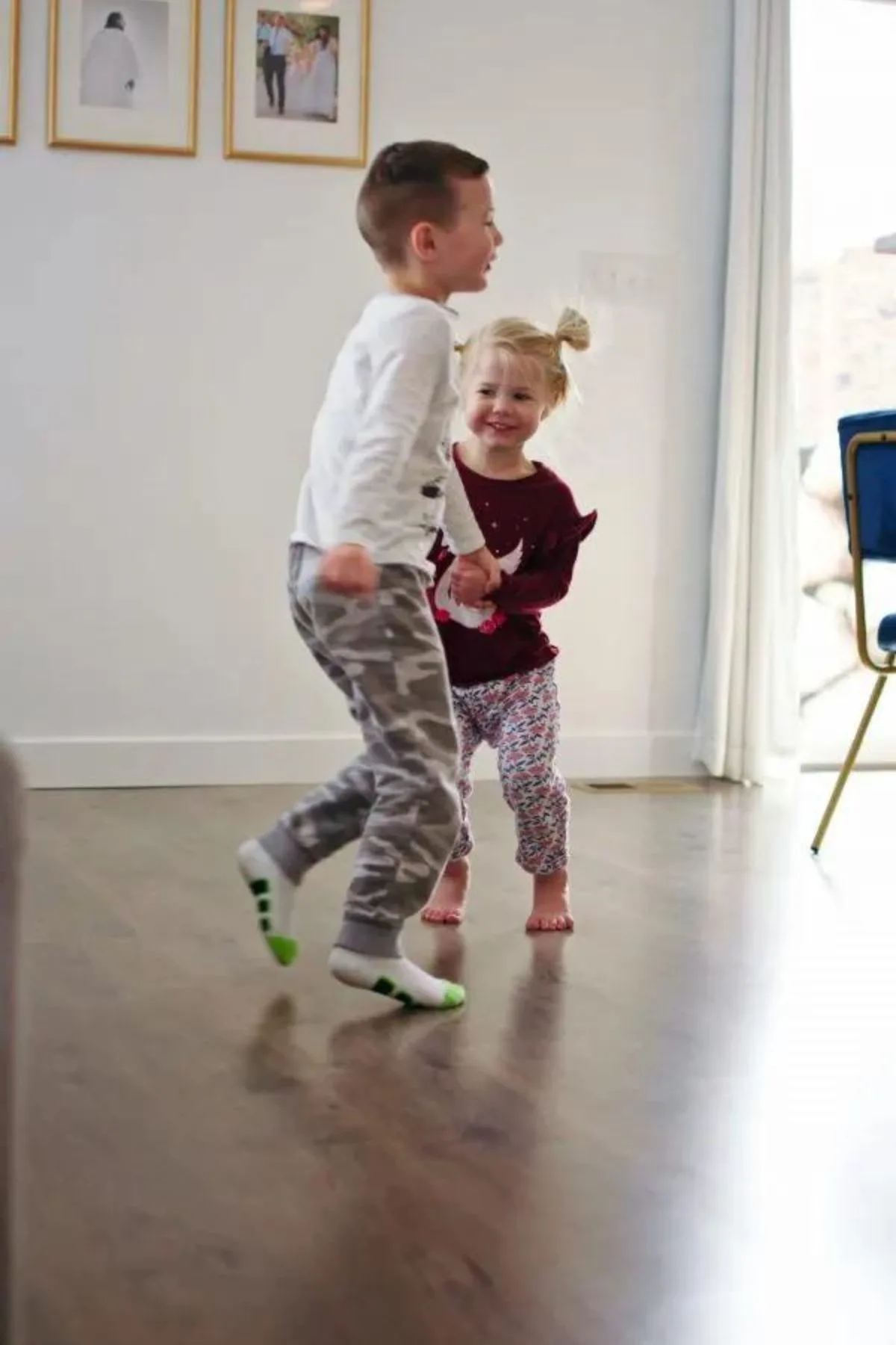 Children dance and clean laminate floors in the dining room.