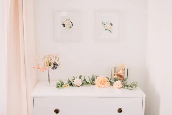 White dresser with flower decor.