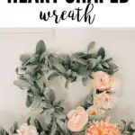 Pinterest graphic with text that reads "How to Make a Heart Shaped Wreath" and a picture of a heart wreath made out of green foliage and pink flowers.