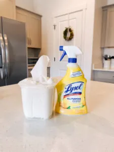 Homemade disinfectant wipes sit on a counter next to Lysol cleaner.
