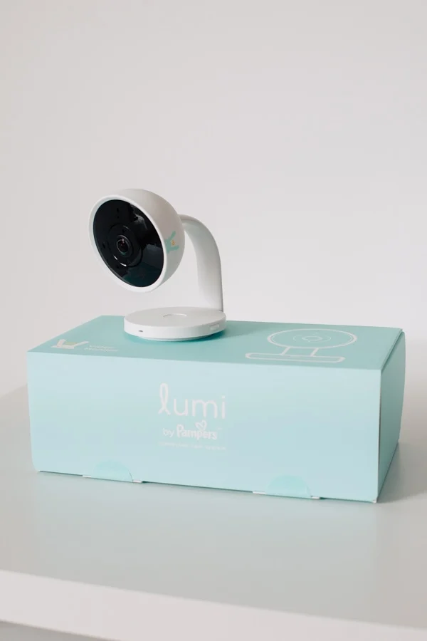 Lumi baby monitor and teal box on a table.