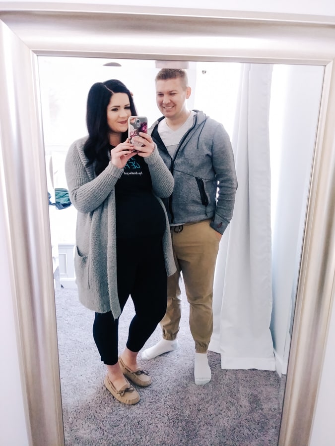 Expecting couple takes photo in the mirror.