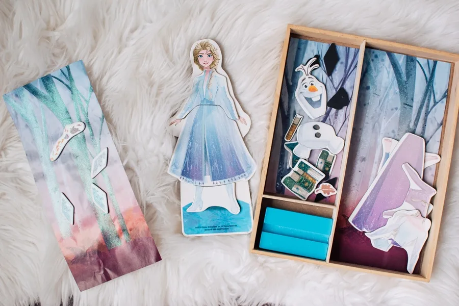 Elsa magnet doll on a white rug.