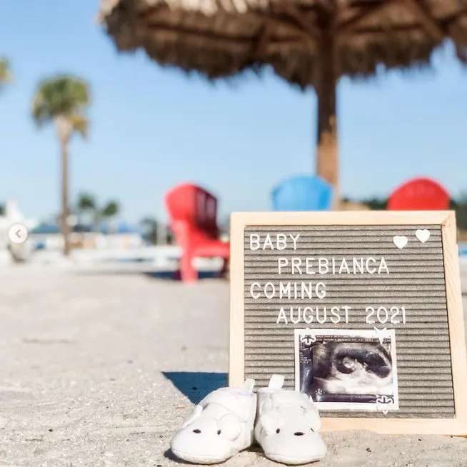 Letter board with ultrasound photo on the beach.