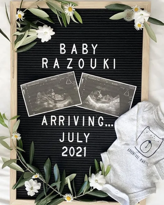 Letter board with ultrasound photos and flowers.