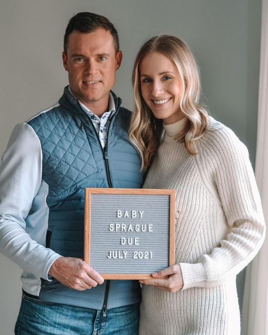 Couple holds gray letter board.