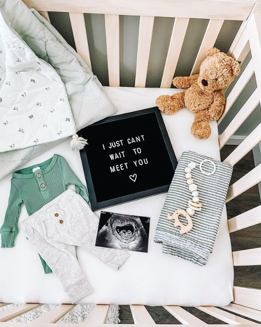 Flat lay of letter board in a crib.