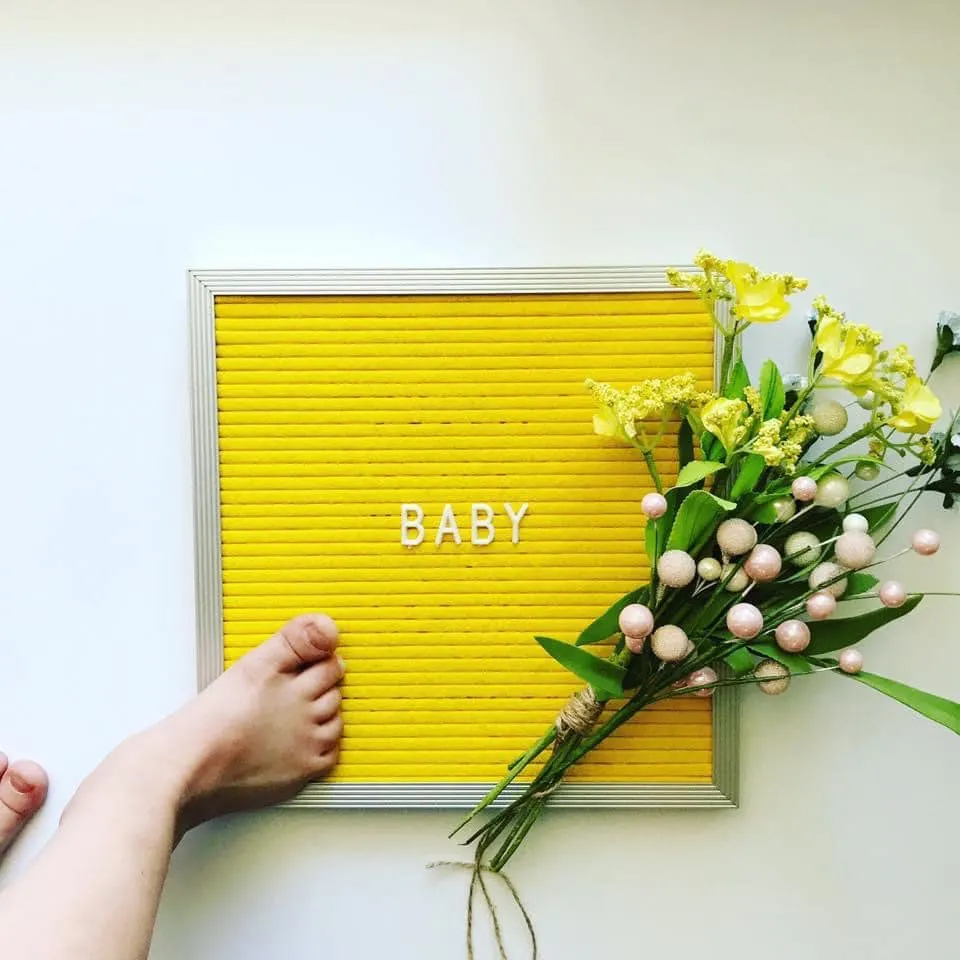 Yellow letter board baby announcement.
