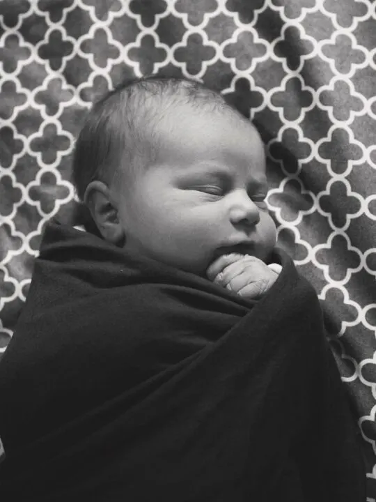 Newborn sleeping at night in black and white.