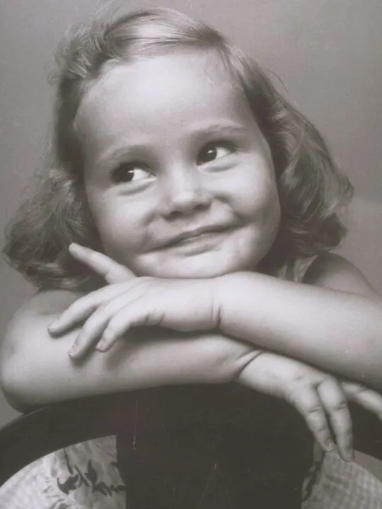 Vintage photo of little girl smiling.