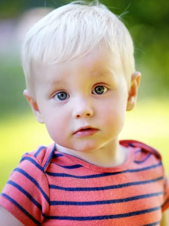 Baby boy in red and blue striped shirt.