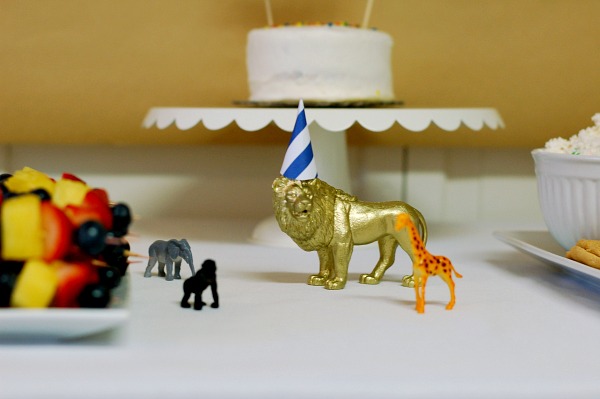 Plastic zoo animals on party table.