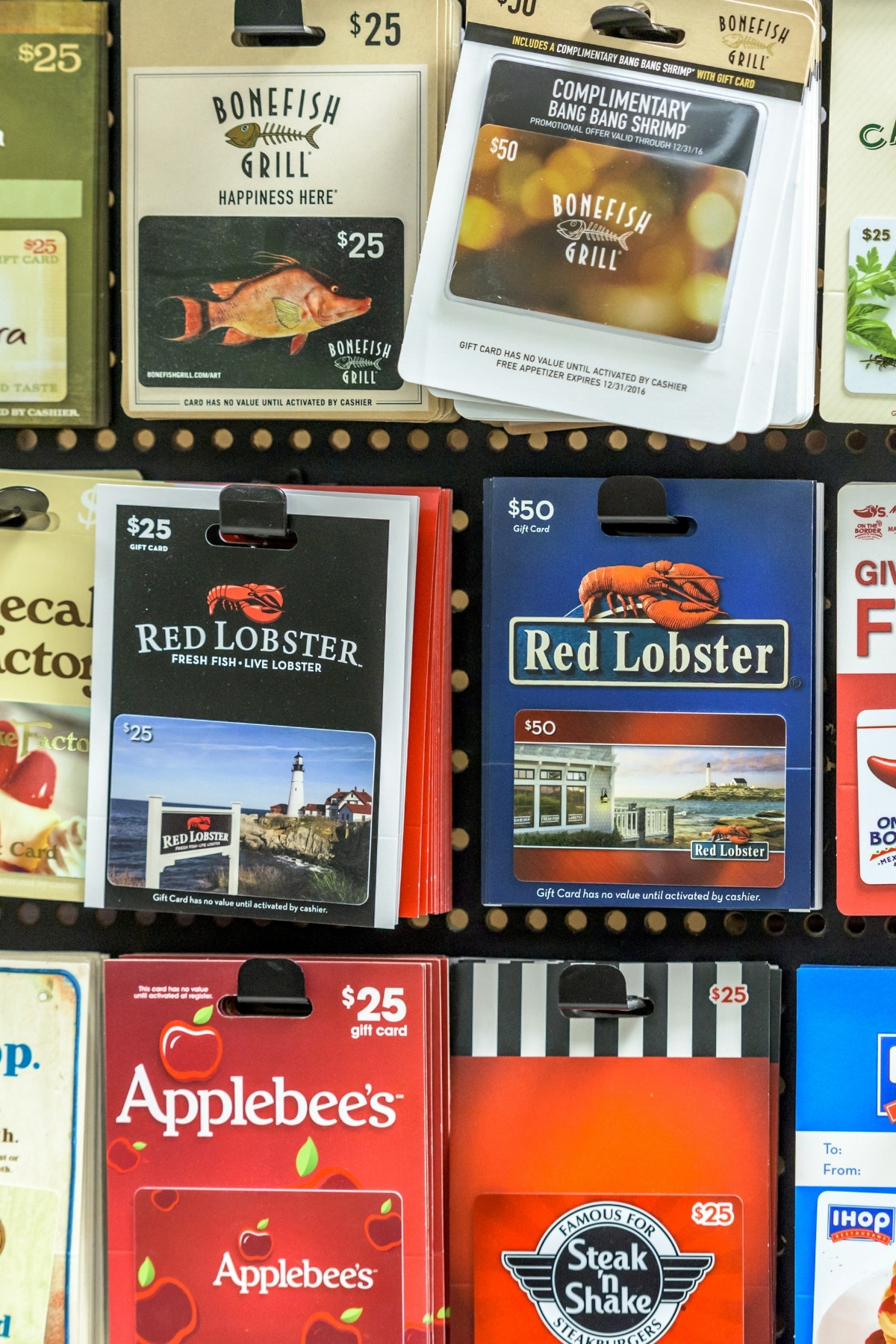 Several different gift cards on display for restaurants and stores.