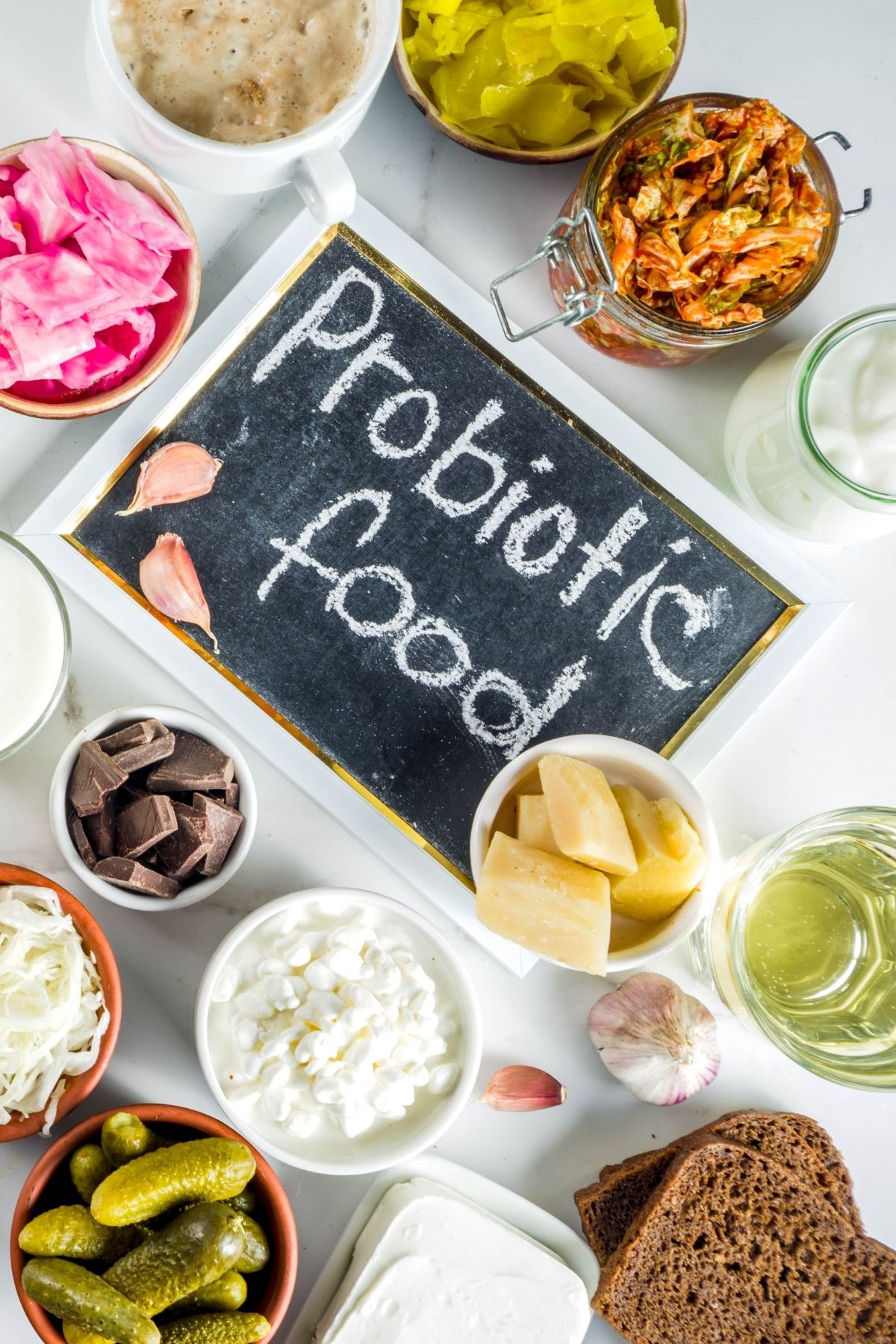 Several different probiotic foods in small bowls surrounding a sign that says probiotic food.