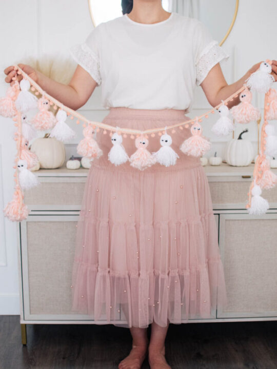 cropped-woman-holds-pink-ghost-garland.jpg