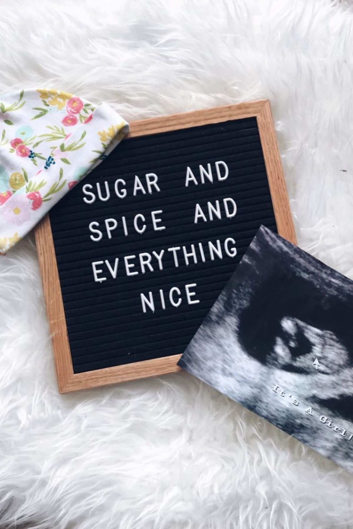 An ultrasound picture next to a sign that says sugar and spice and everything nice.