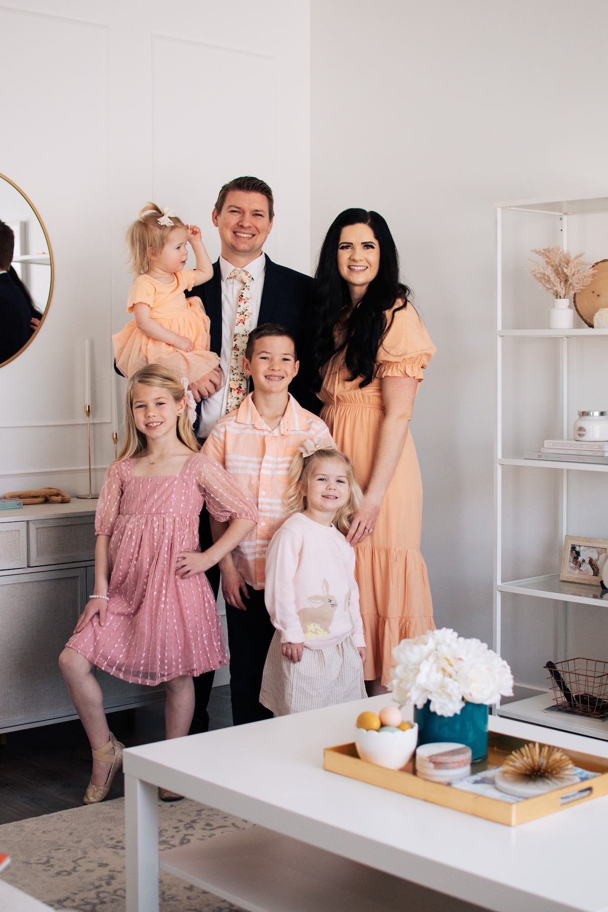 Jessica Ashcroft poses with her family of four kids in her home.