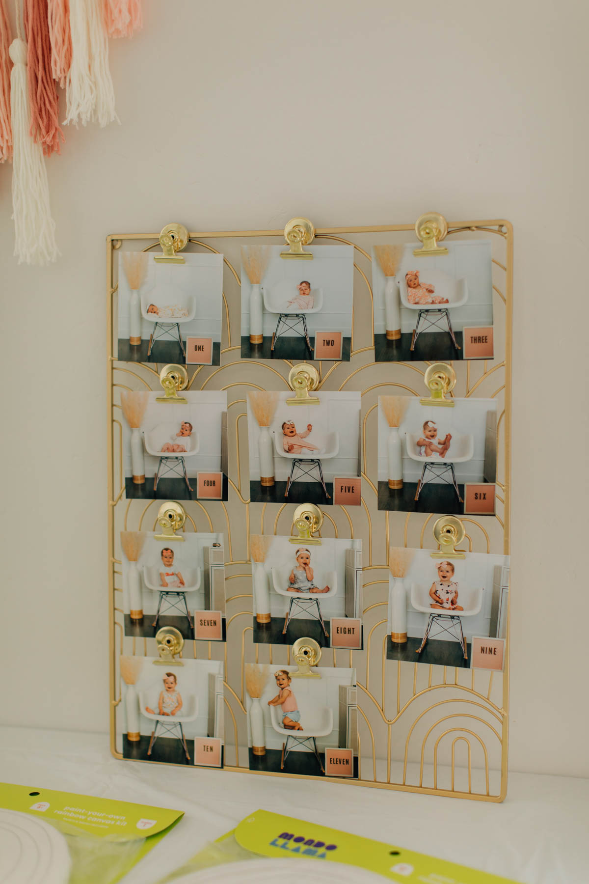 Rainbow metal display with monthly baby photos in gold metal magnets.