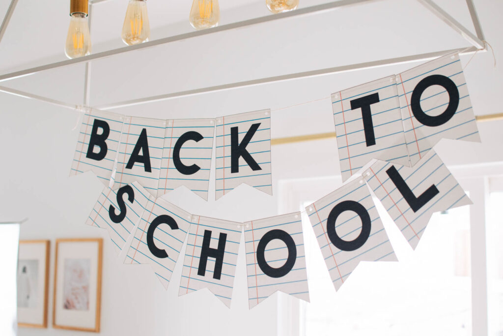 Back to school sign hanging from chandelier.