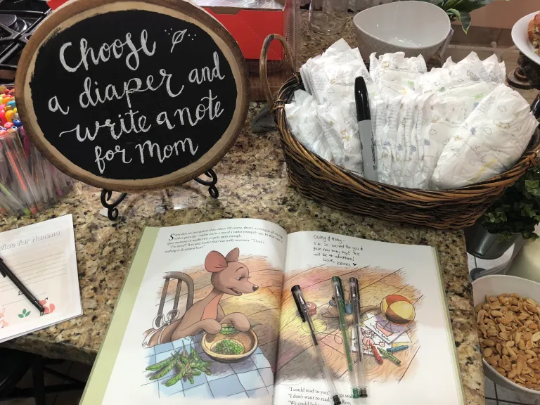 A diaper signing station at a woodland-themed baby shower.