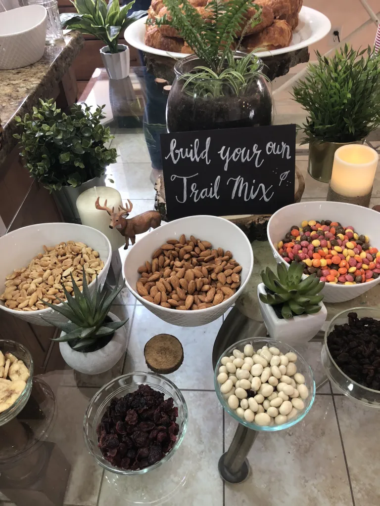 Woodland-themed baby shower trail mix bar.