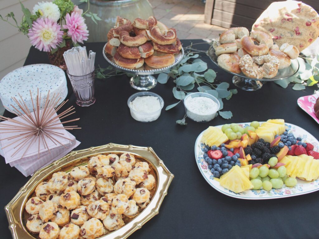 Food at a baby shower party including a fruit platter and dessert.