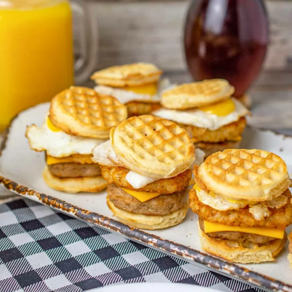 Mini breakfast sandwiches with waffles as the bread and quail eggs.