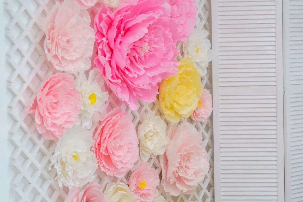 Pink and yellow paper flowers decorated a lattice backdrop.